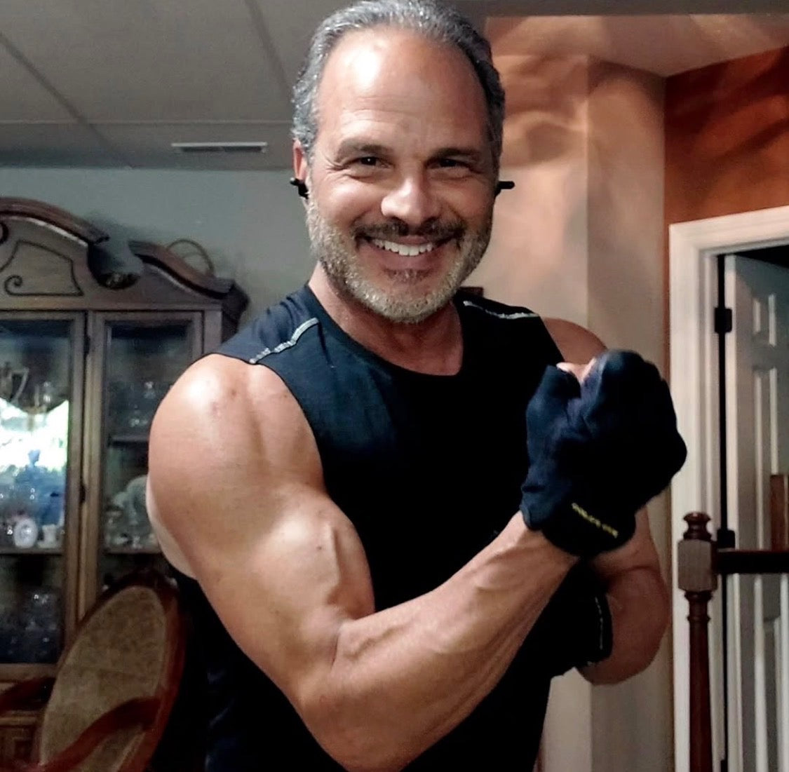 Lifter in his fifties smiling mid-workout in the gym